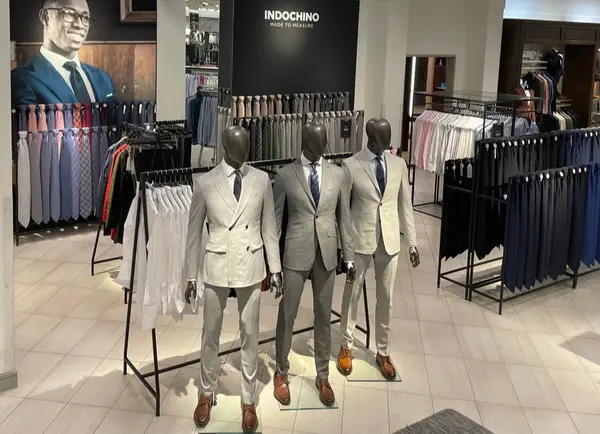 An in-store display featuring suits made by the brand Indochino.