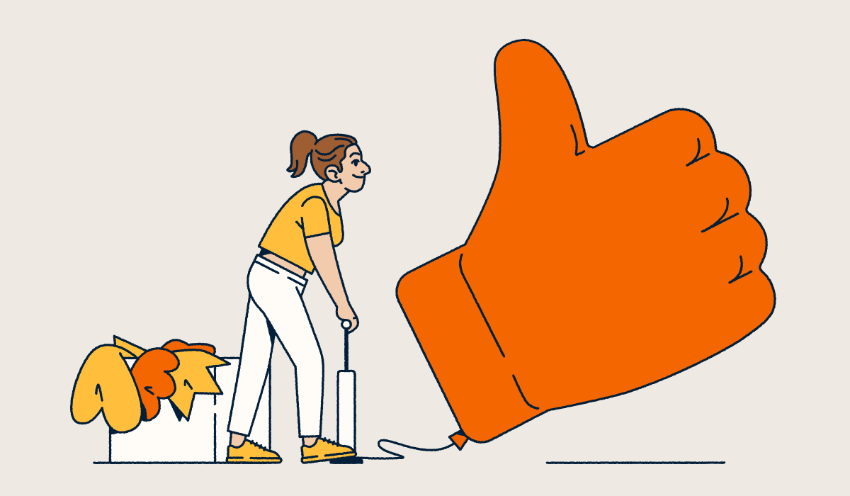Person blowing up a large thumbs up balloon.